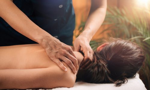 Woman Enjoying Deep Tissue Massage in Salon